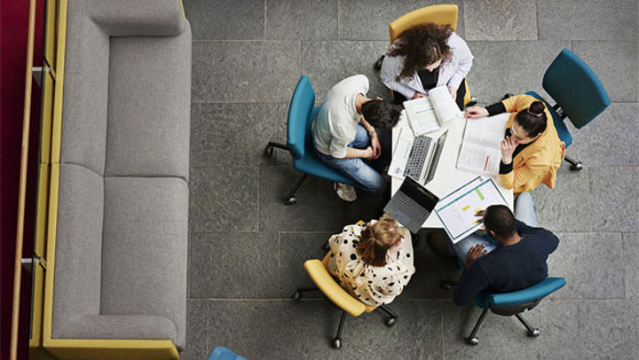 A group of business students sat around a desk